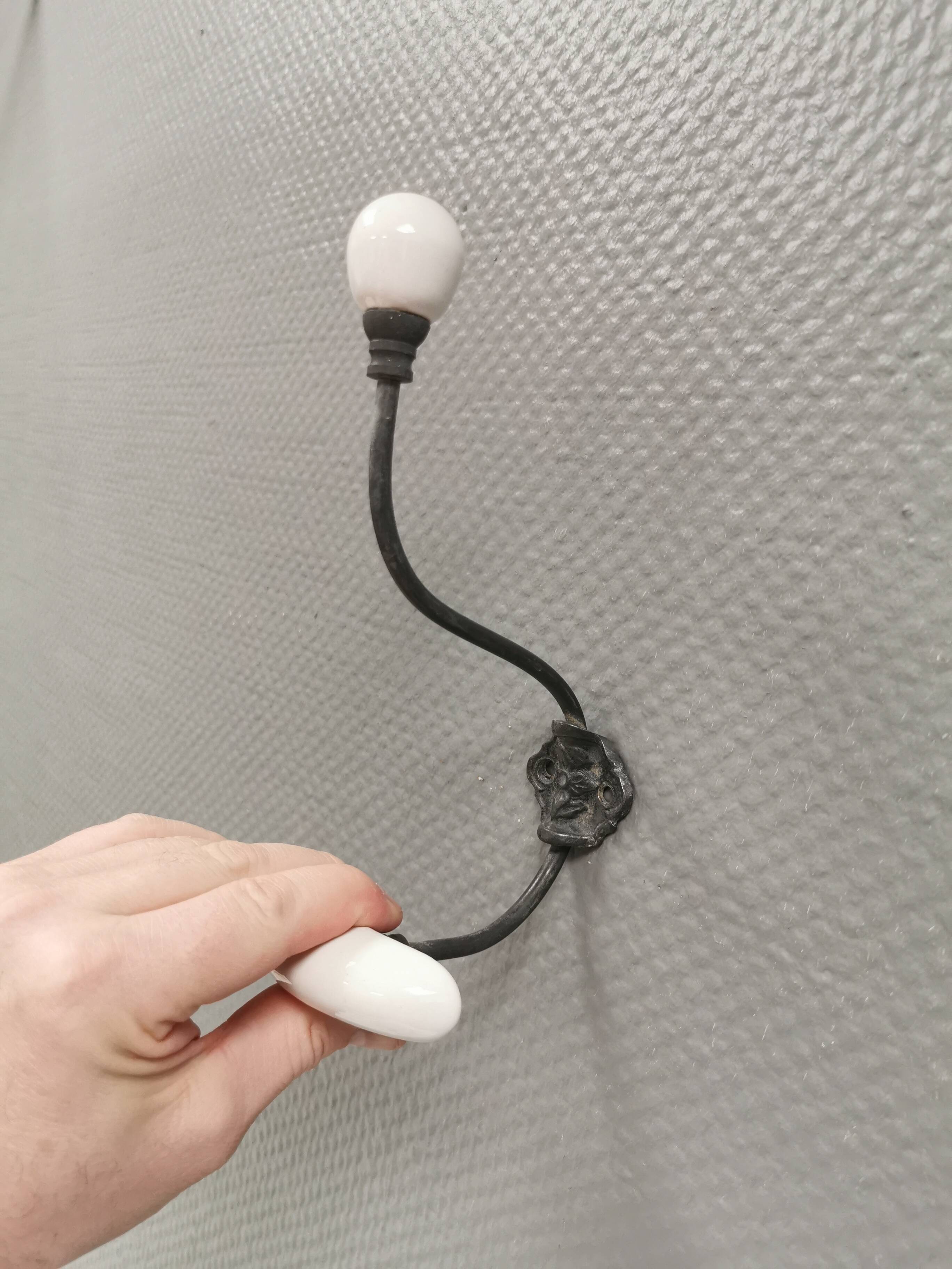 Coat hooks made of galvanized brass and raw white porcelain