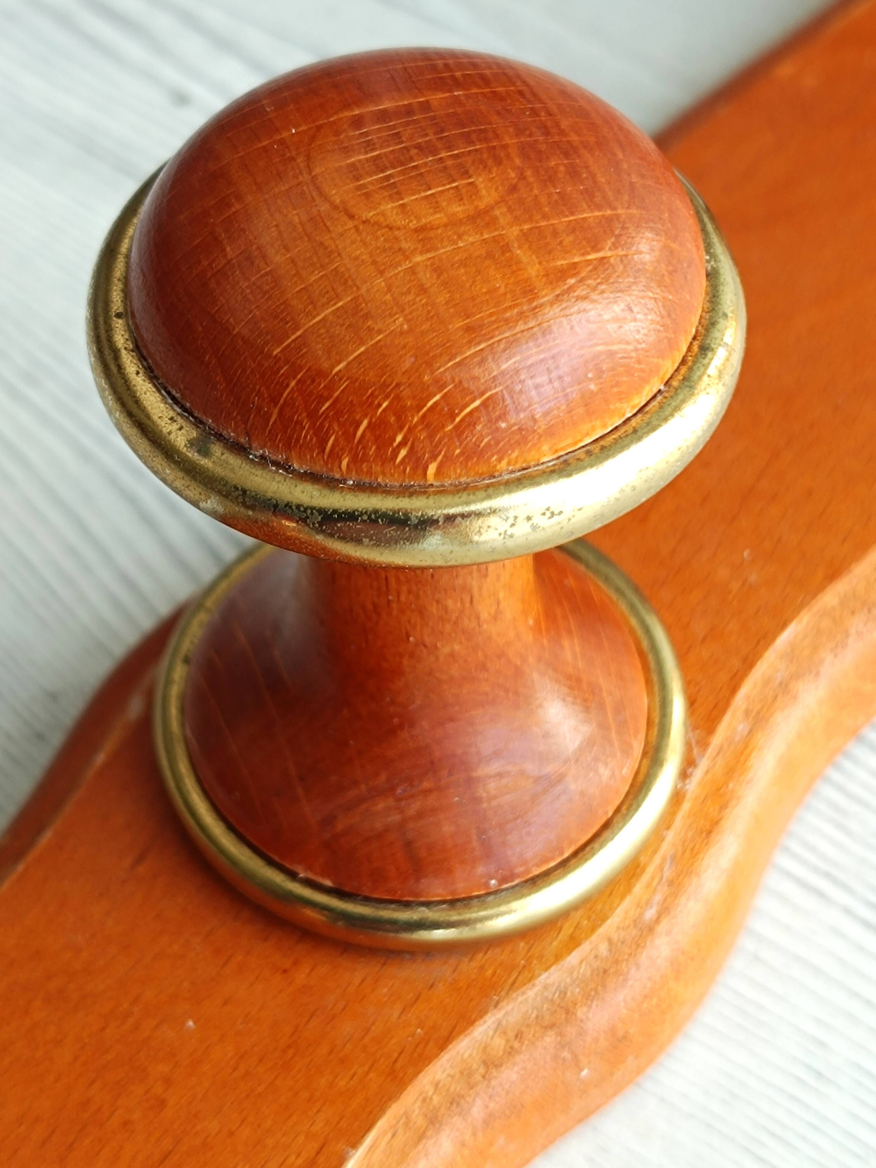 Wall-mounted coat rack in wood and brass