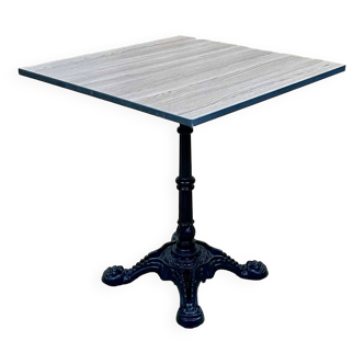 Modern bistro table, cast iron base, laminated top