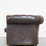Old dark brown 3-seater cowhide chesterfield sofa with lots of character