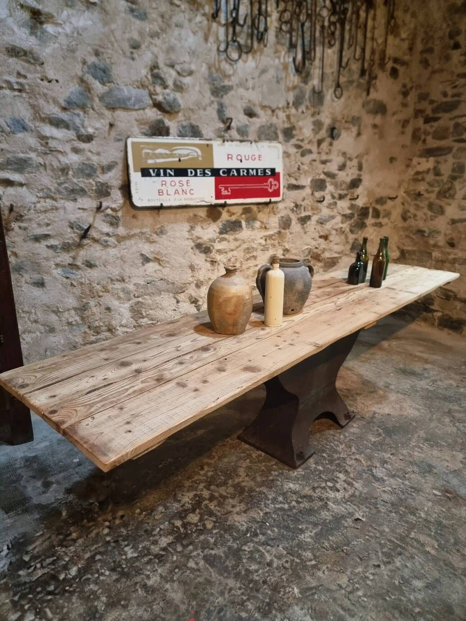 Old French industrial table with a cast iron base and a pine top.