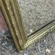 Louis Philippe mirror in gilded wood with an openwork frieze.