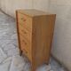 Vintage chest of drawers in raw wood.