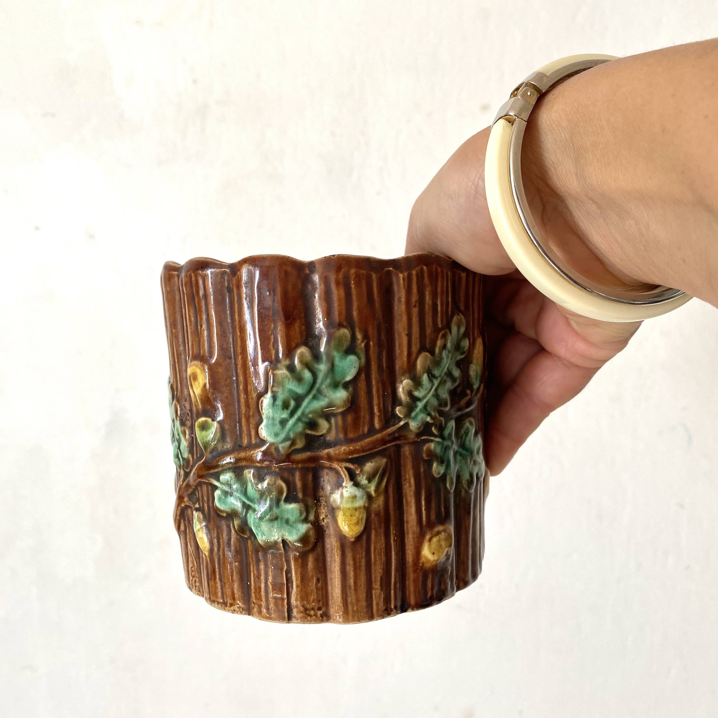 Antique slip pot with acorn decoration