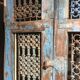 Openwork indian door in metal and blue wood
