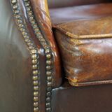 Comfortable, elegant, stately wing chair made of sheepskin in a beautiful warm color