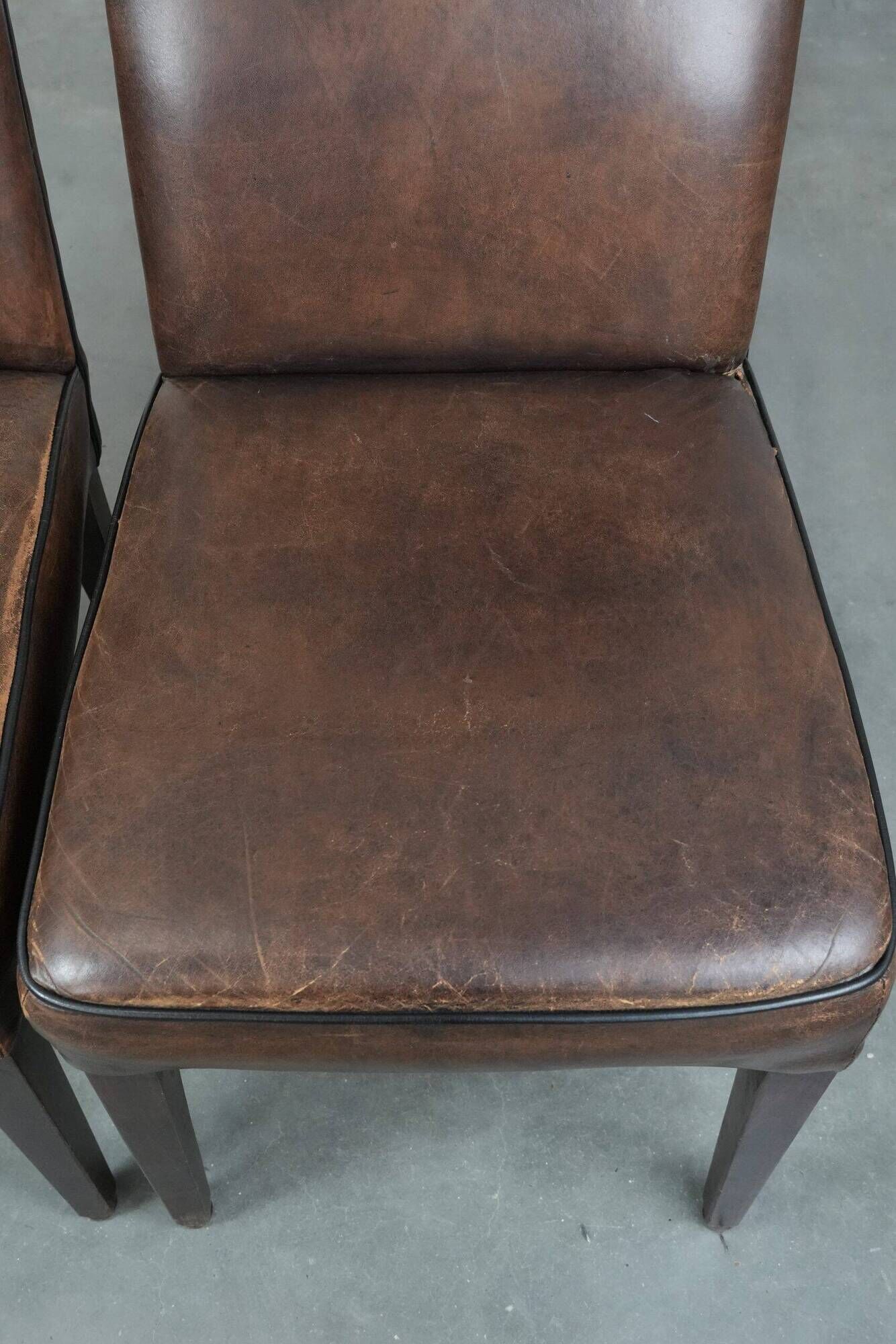 Set of 6 vintage sheepskin dining chairs finished with black piping