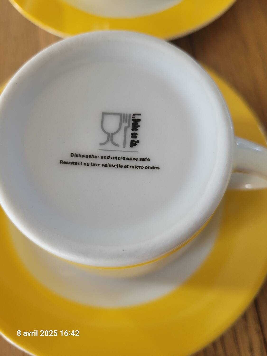 4 yellow and white cups and saucers