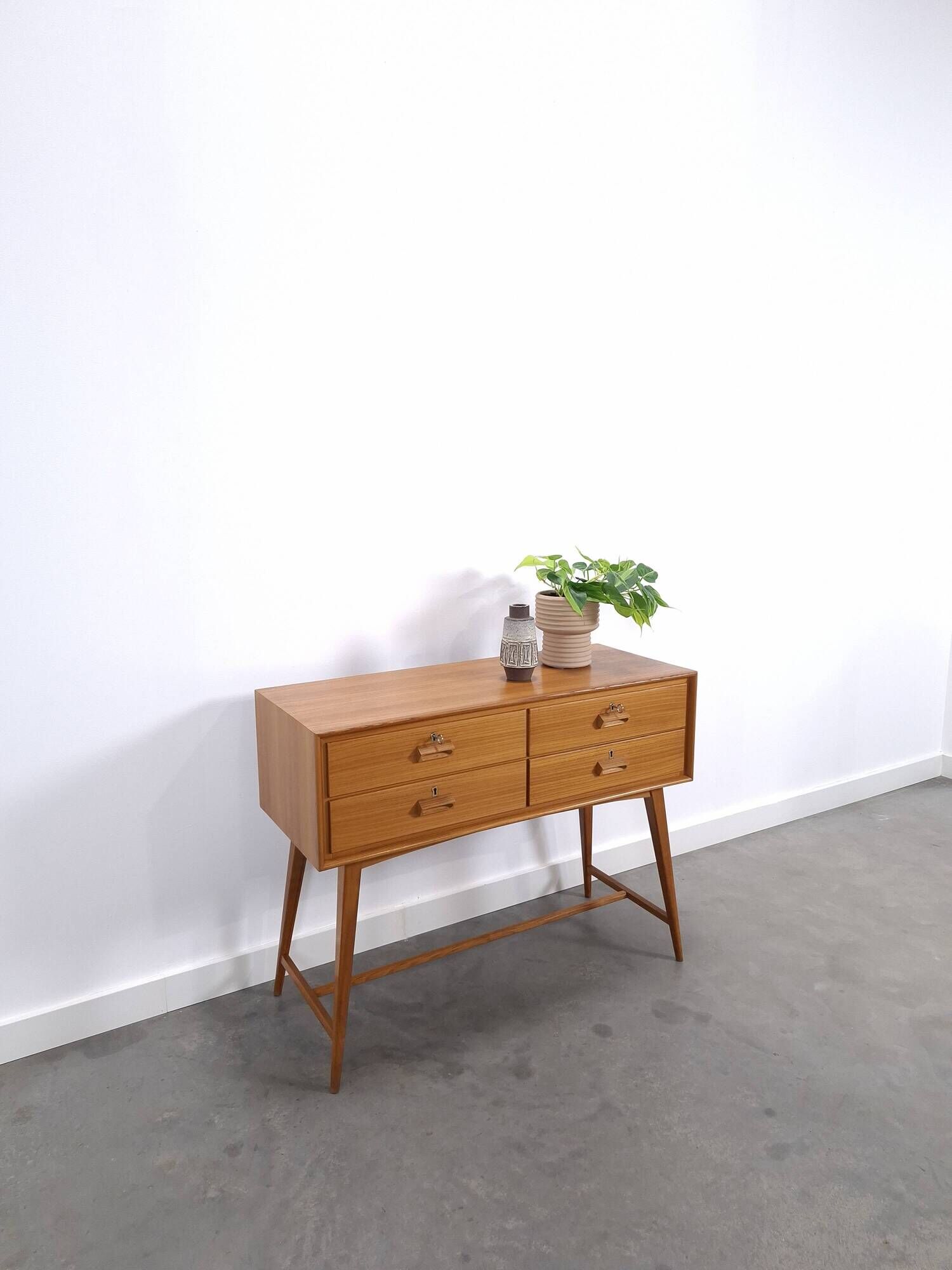 Vintage teak Danish chest of drawers with high slanted legs, side table, sideboard.