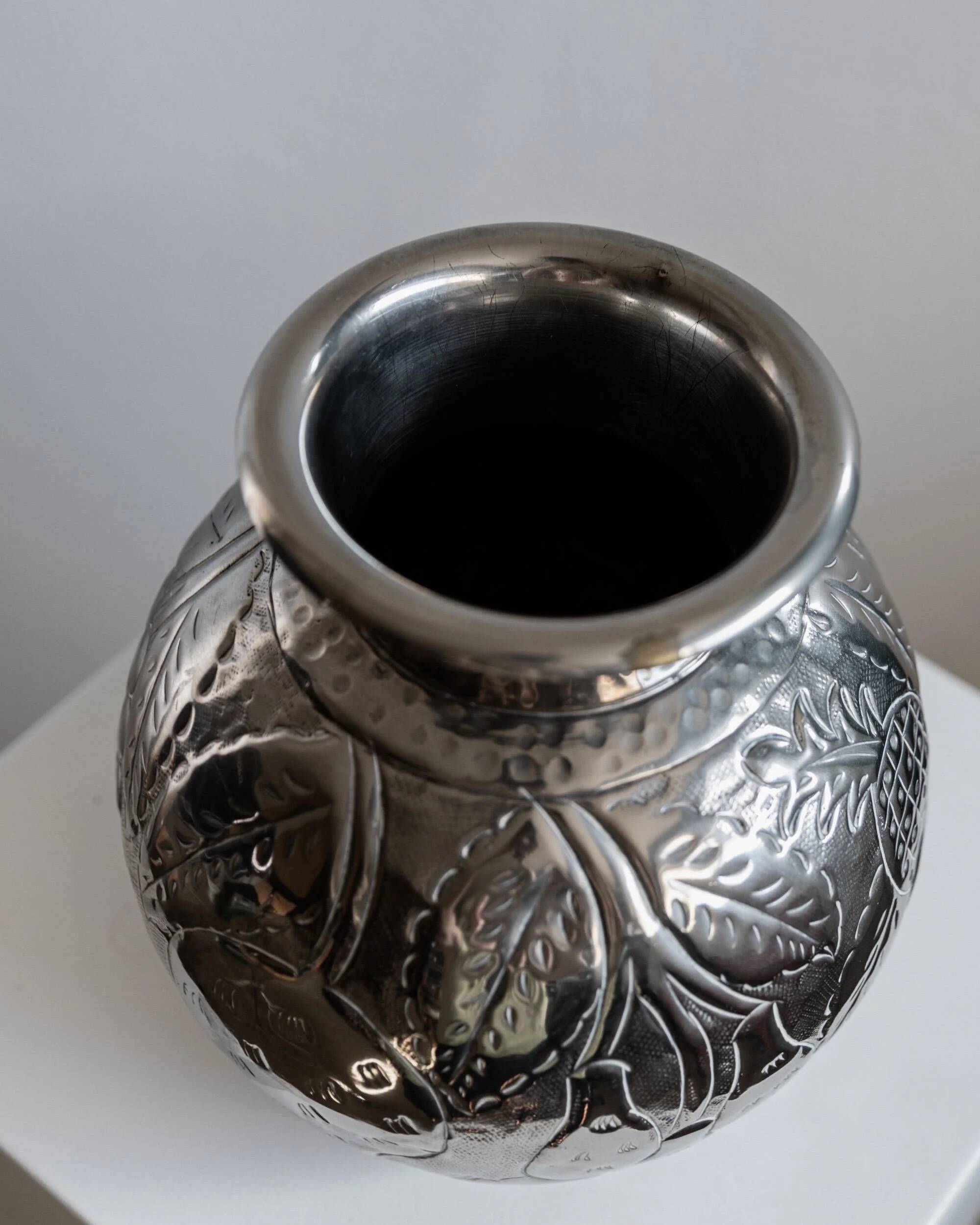 Vintage Italian vase in nickel-plated brass from the 1960s, hand-hammered relief of fruits and leaves.