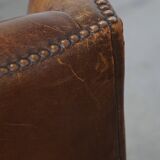 Cognac-colored sheepskin wing chair in English style