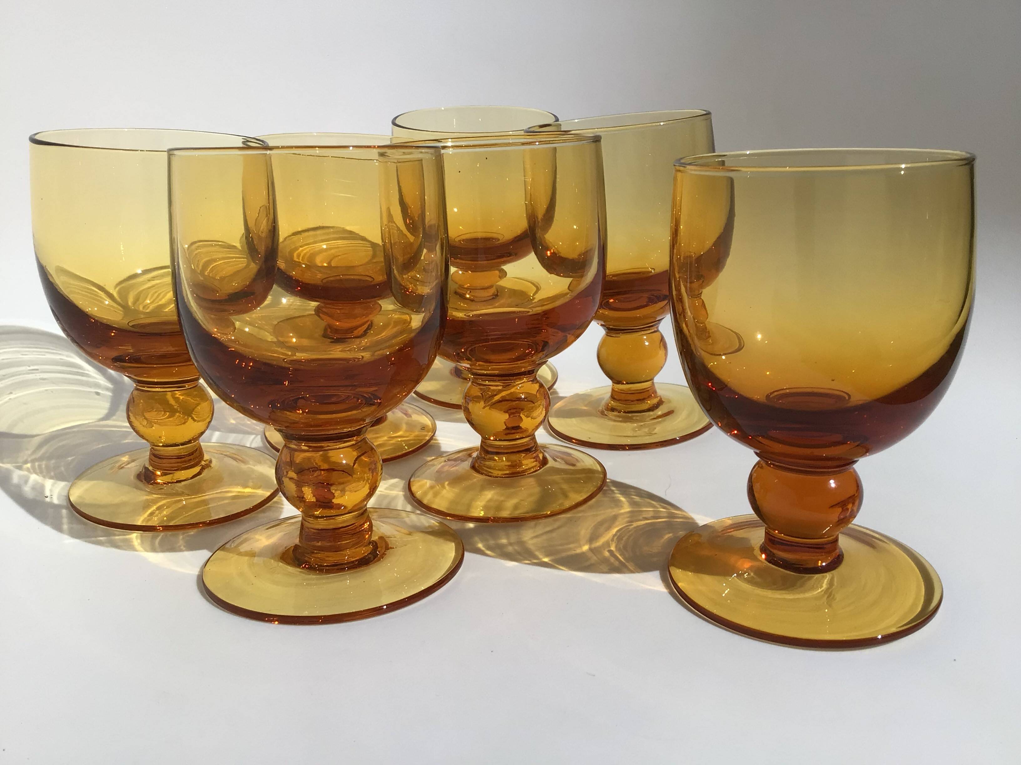 7 Amber stemmed glasses