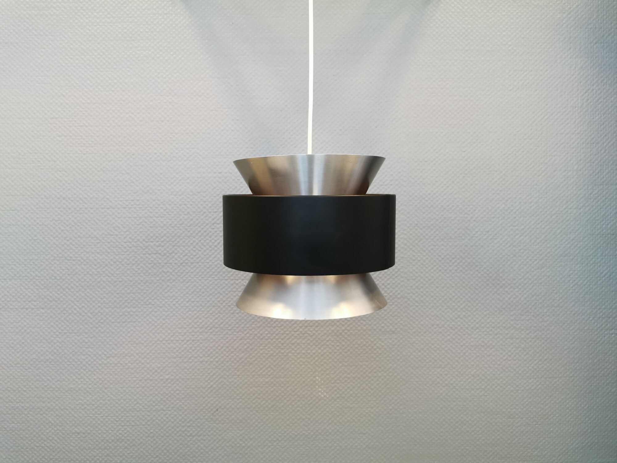 Hanging lamp,  of silver coloured aluminium with black "ring" and orange inner contrast lacquer.