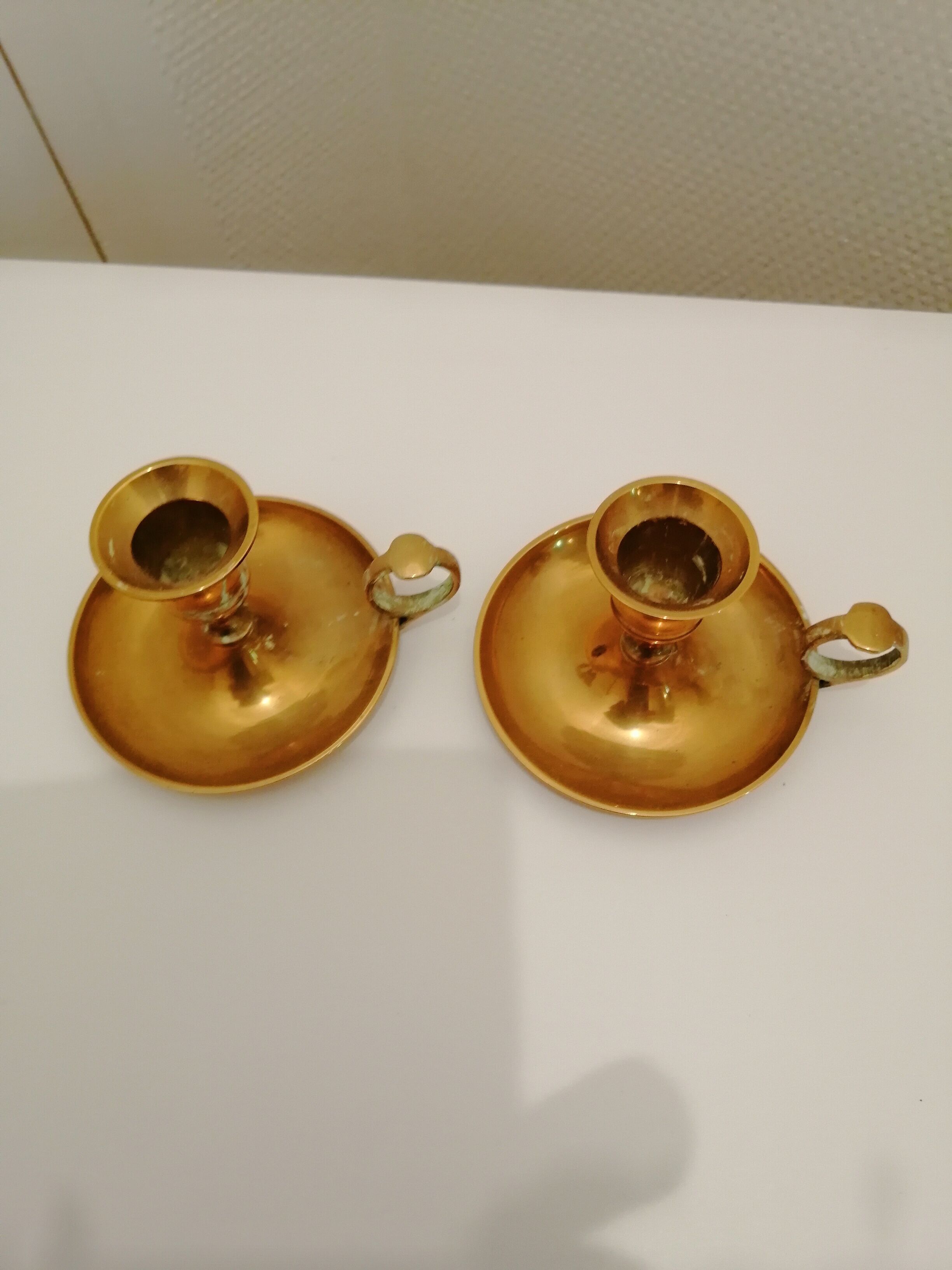 A PAIR OF SMALL COPPER CANDLE HOLDERS