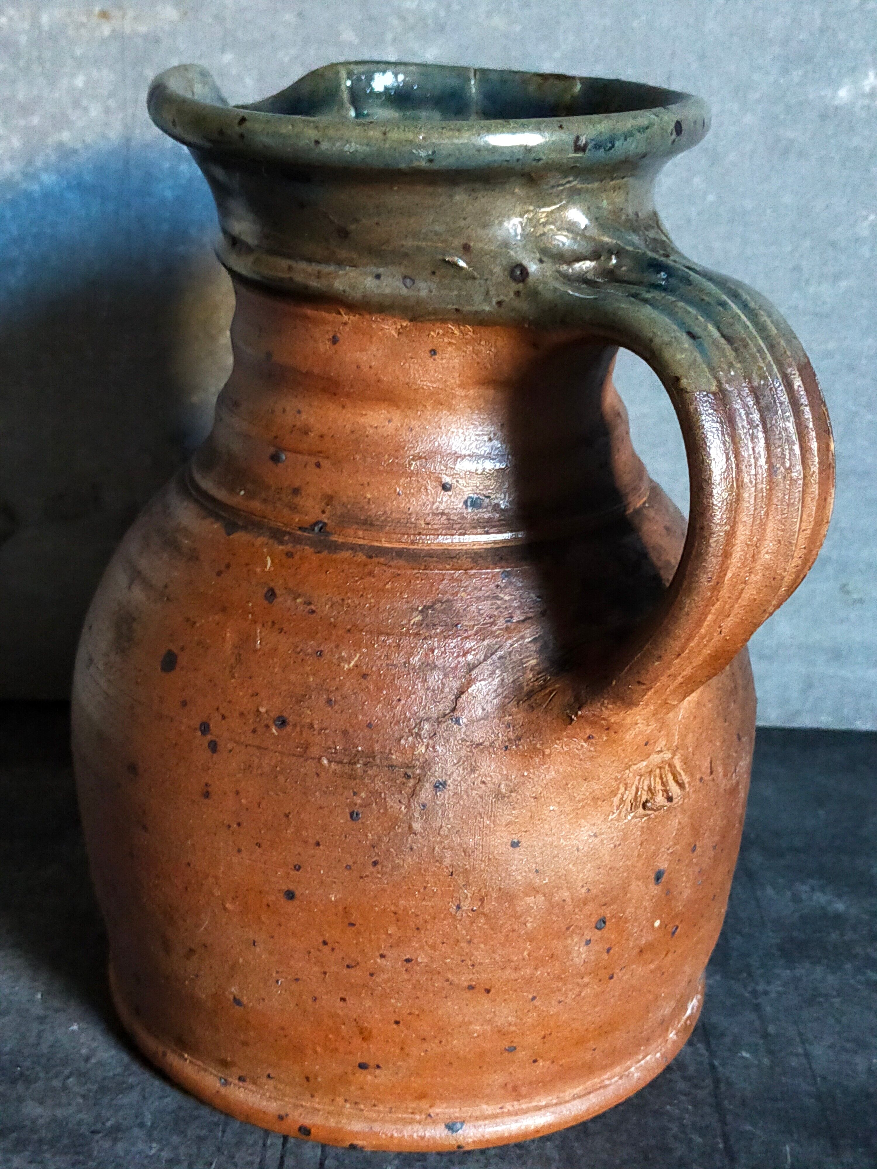 Pitcher traditional pottery Folk art in old enamelled sandstone