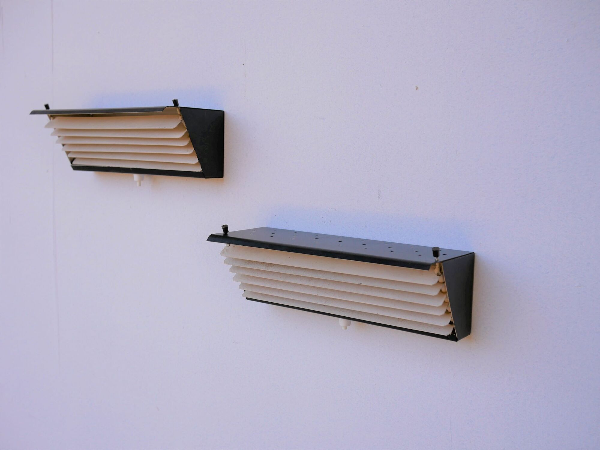 Pair of modernist metal wall light model 212, by Jacques Biny for Luminalite