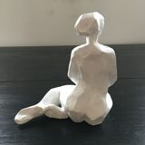 Statuette woman seated in plaster