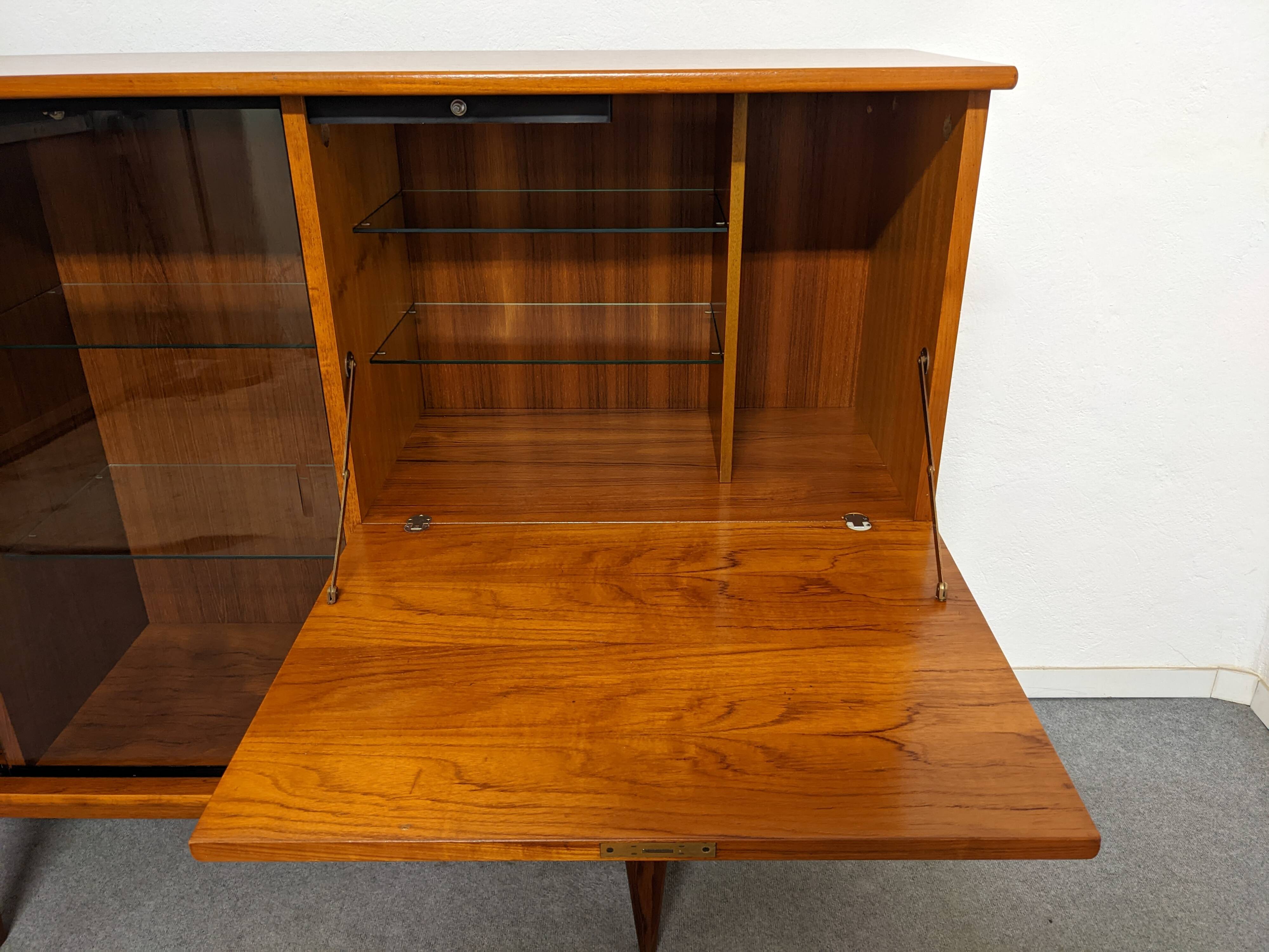 High sideboard, display cabinet and secretary, Scandinavian in teak, France around 1960.