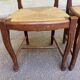 2 dining chairs with carved solid wood and rush seats in Louis XV shell style.
