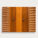 Rattan wardrobe and its compass-legged chest of drawers, 1960