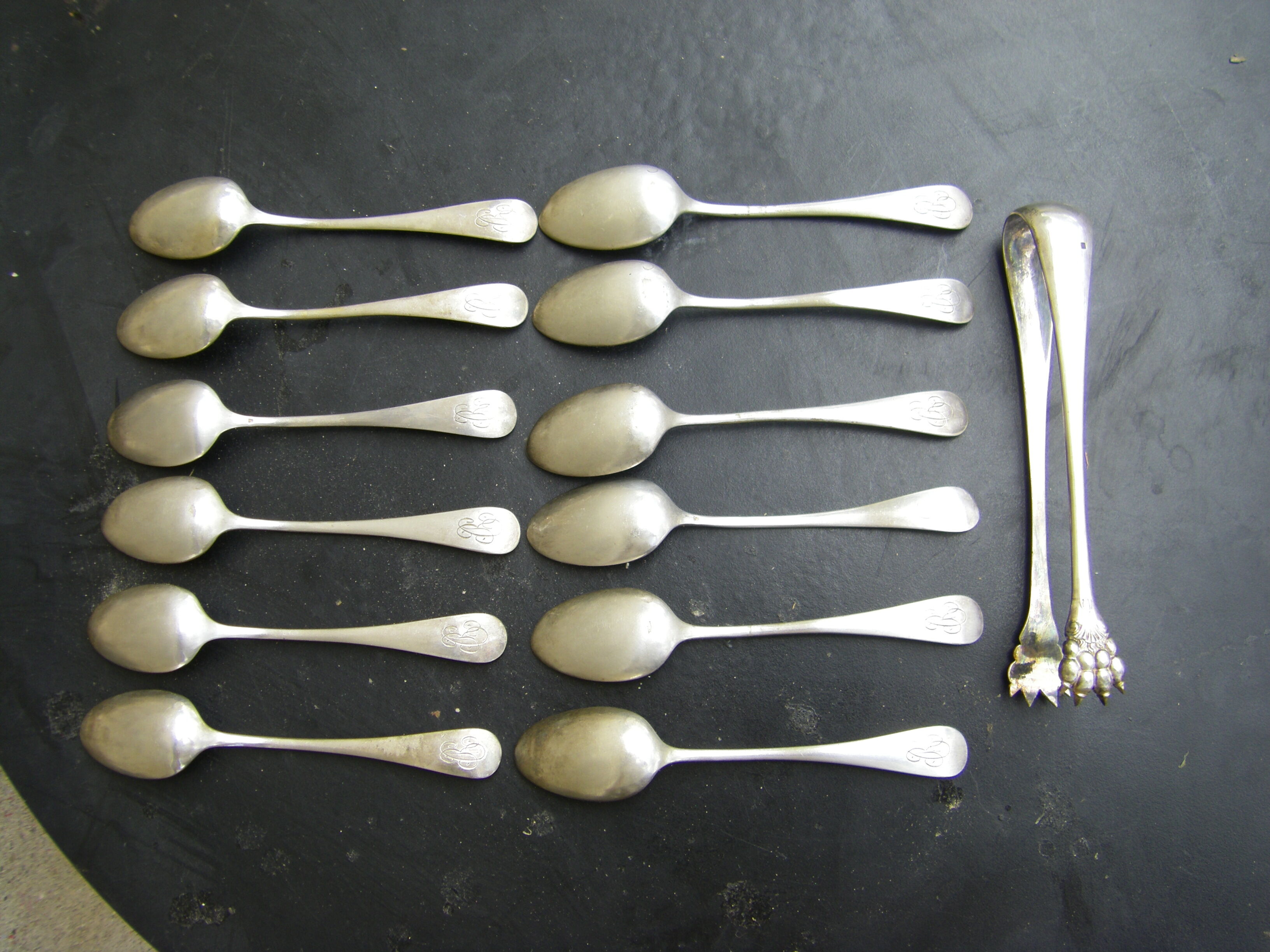 Set of twelve teaspoons and a sugar tongs