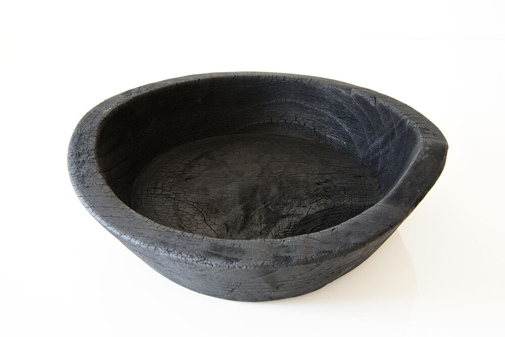 Cut / empty pocket in burning wood. shou-sugi-ban