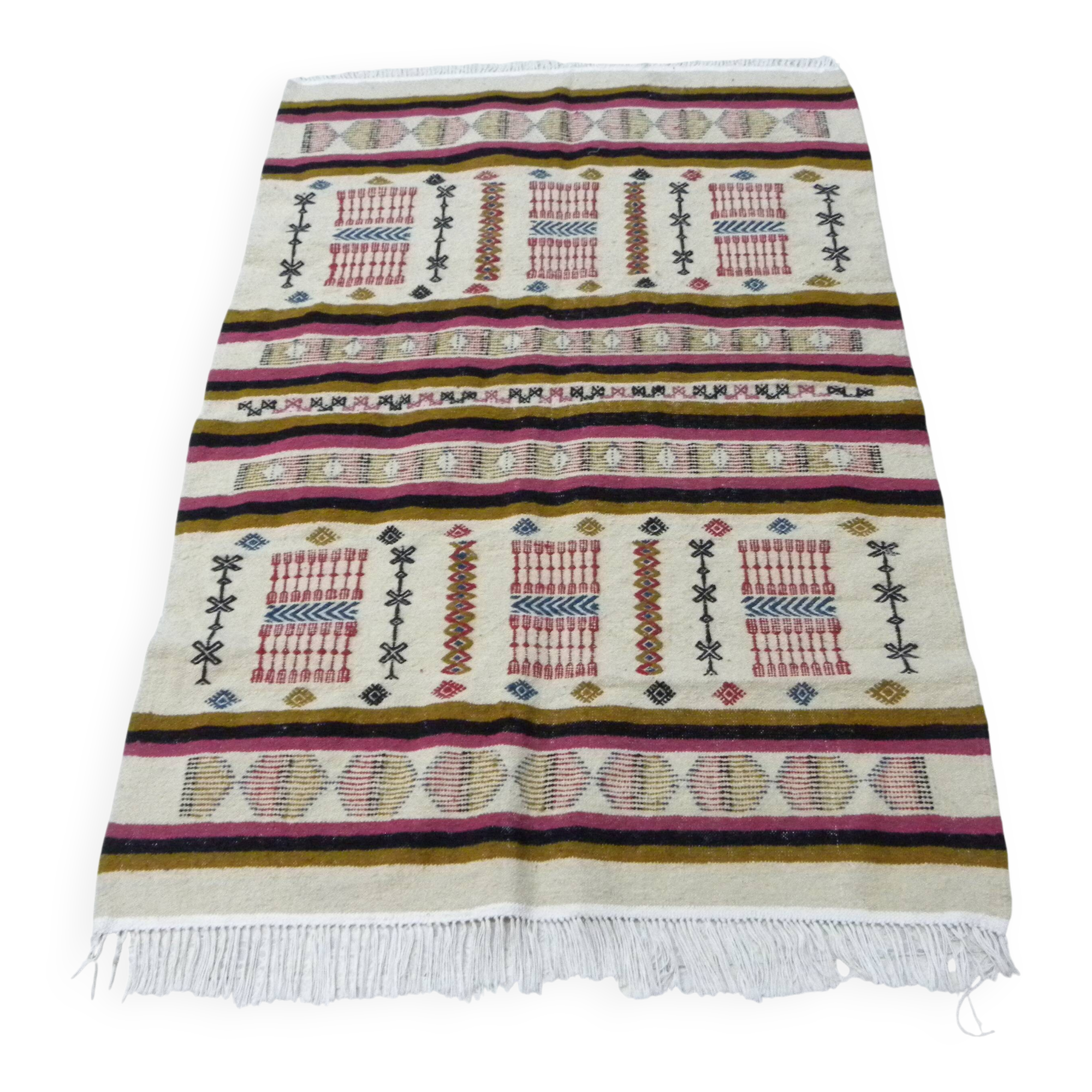 Handmade Berber kilim rug with multicoloured tribal motifs.