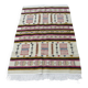 Handmade Berber kilim rug with multicoloured tribal motifs.