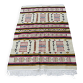 Handmade Berber kilim rug with multicoloured tribal motifs.