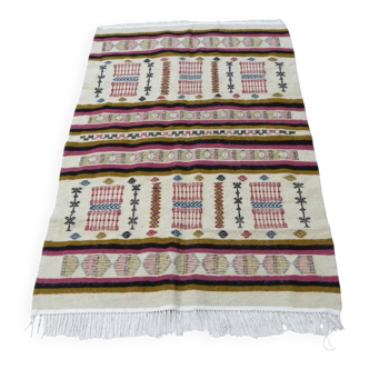 Handmade Berber kilim rug with multicoloured tribal motifs.