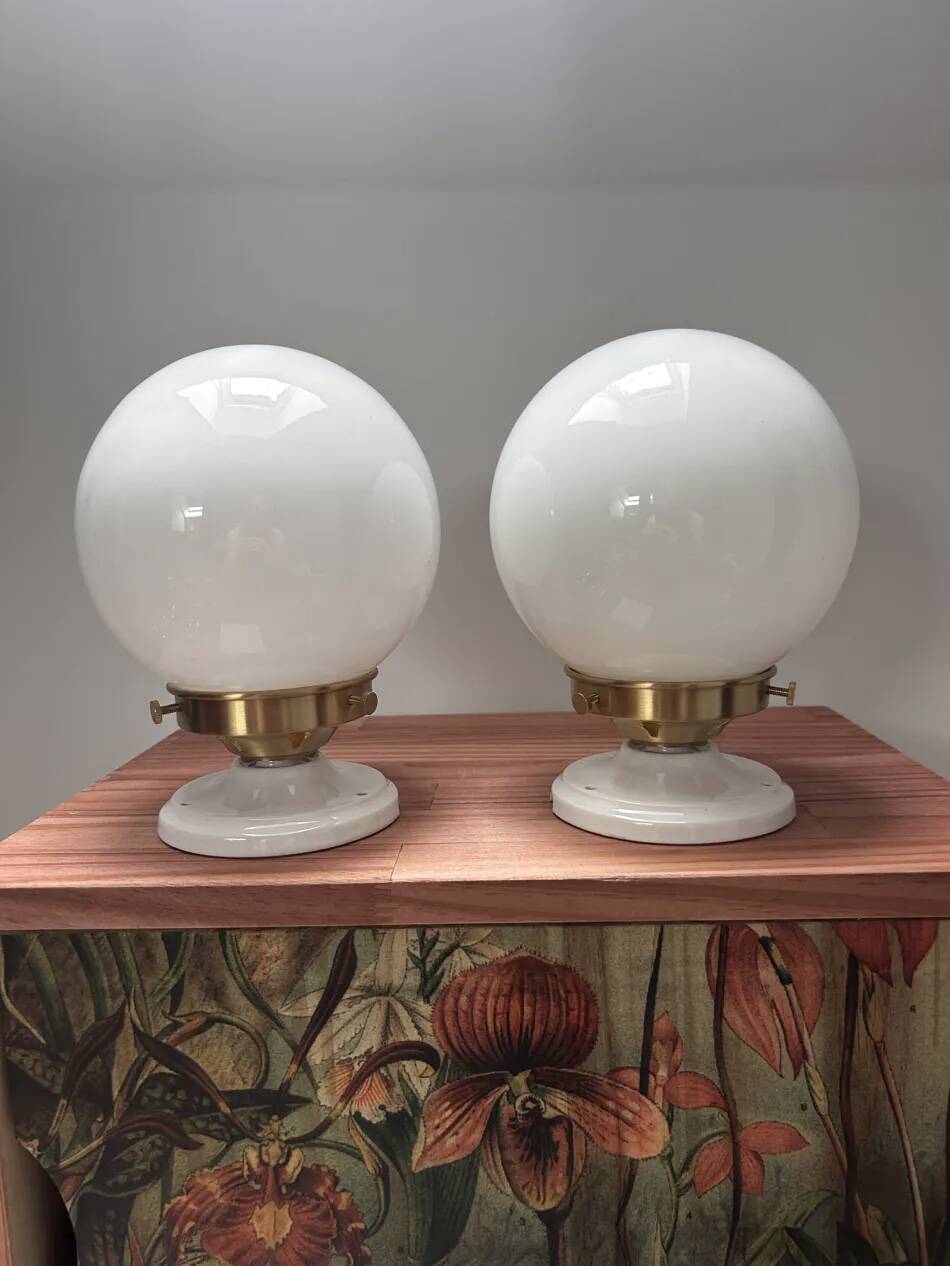 Pair of wall sconces with white opaline globes