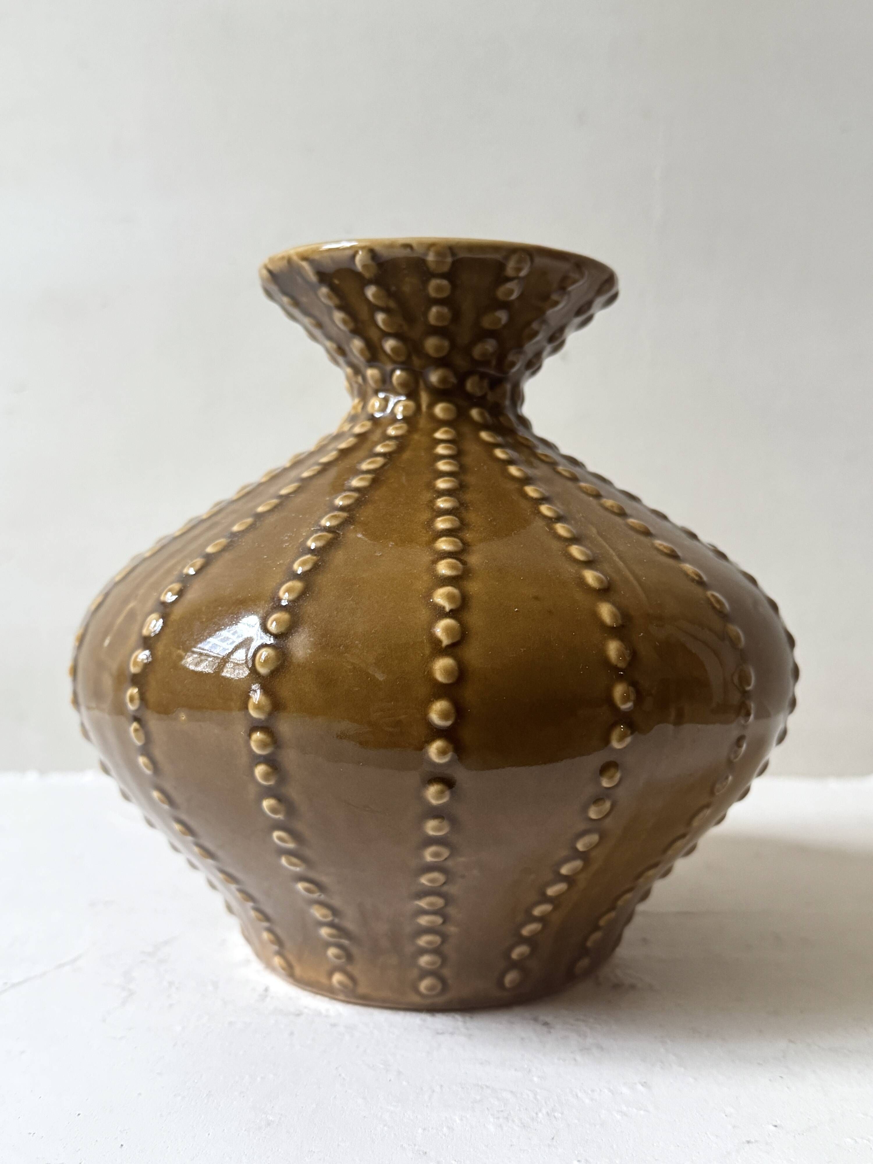 Pyriform vase in glazed ochre ceramic and beads.