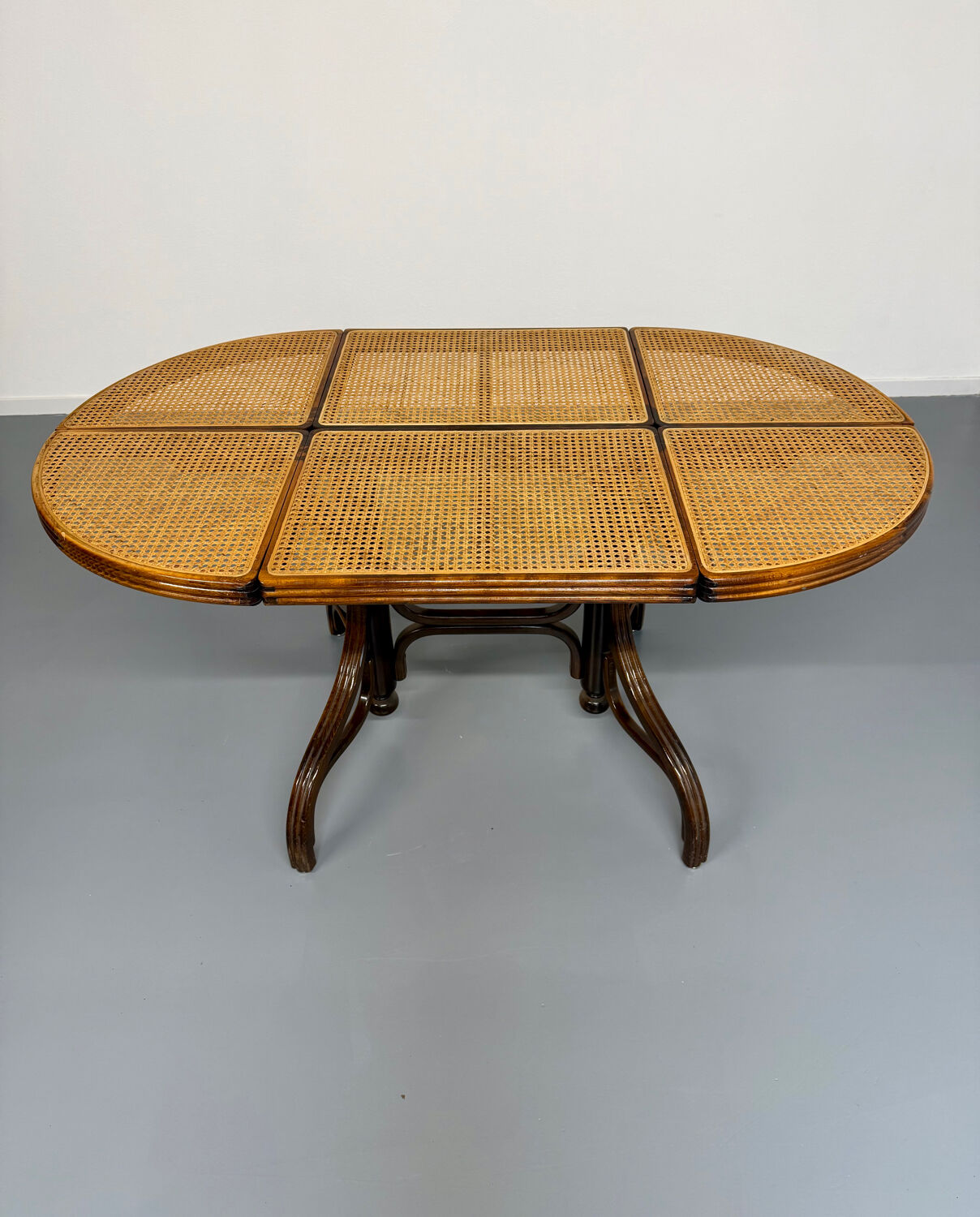 Vintage dining table with a cane top by Mundus from the 1970s.