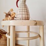 Antique stool with wood and cream caning.