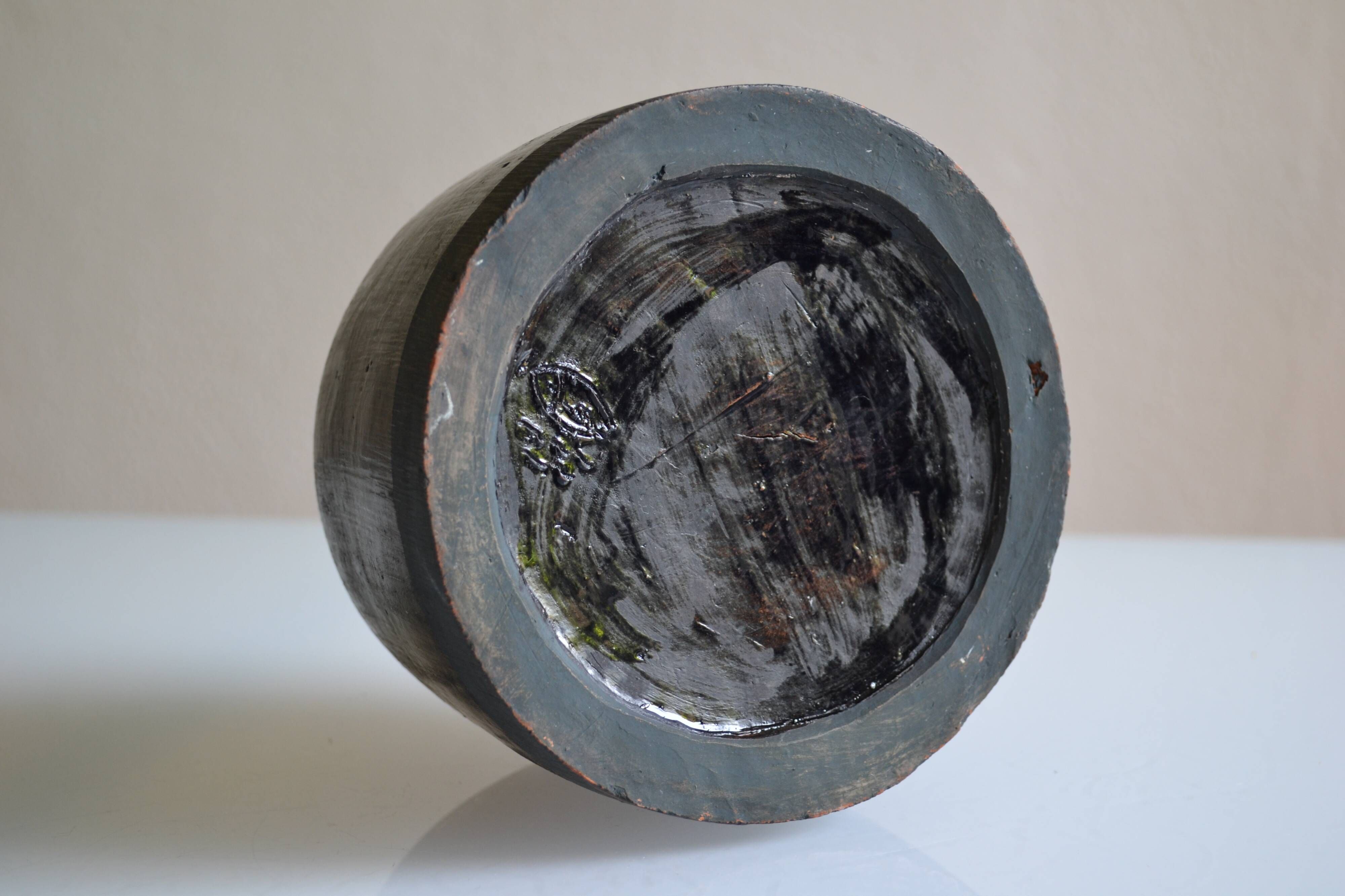 Ceramic vase with a signature fish to identify.