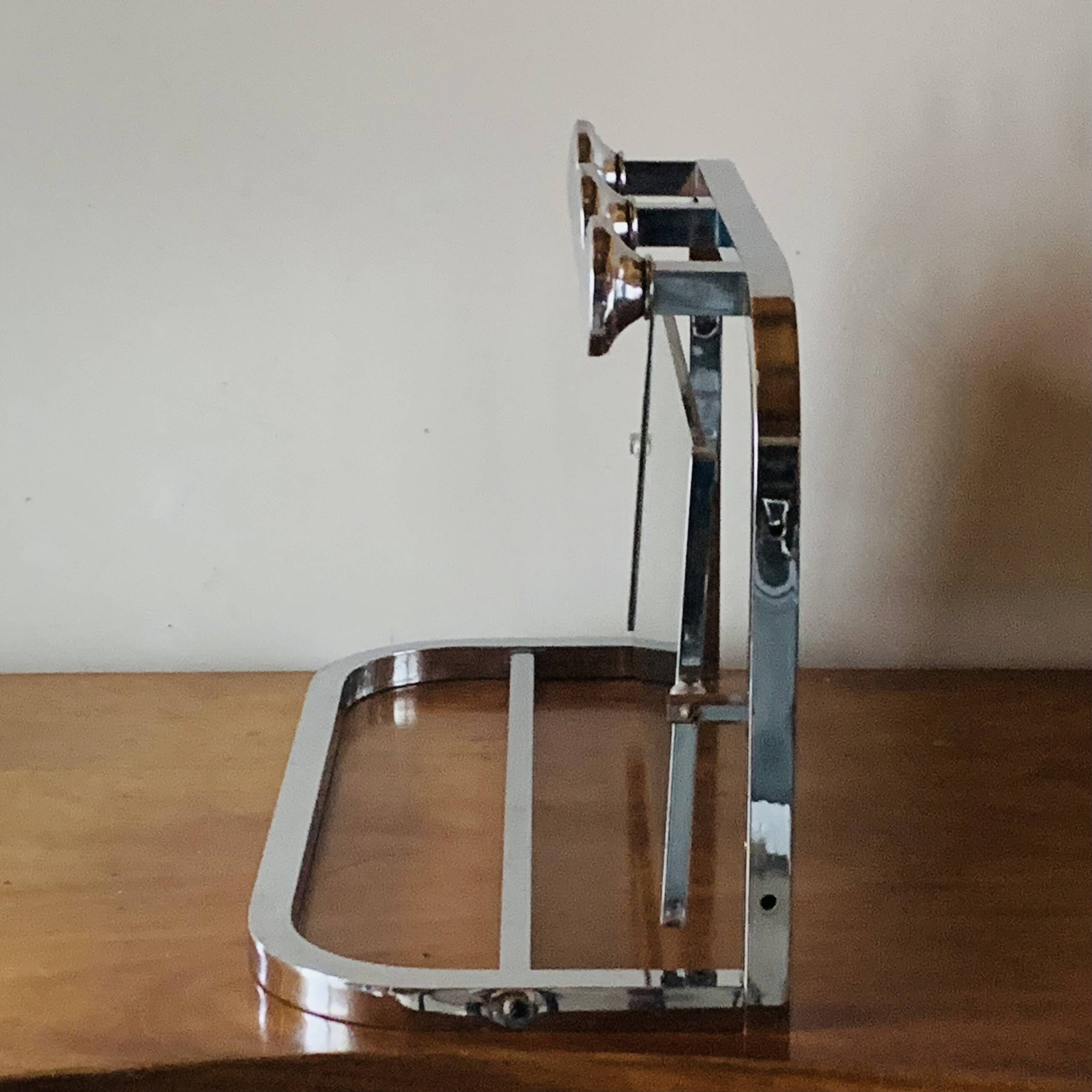 Vintage wall-mounted coat rack in chrome metal with integrated mirror and hat rack