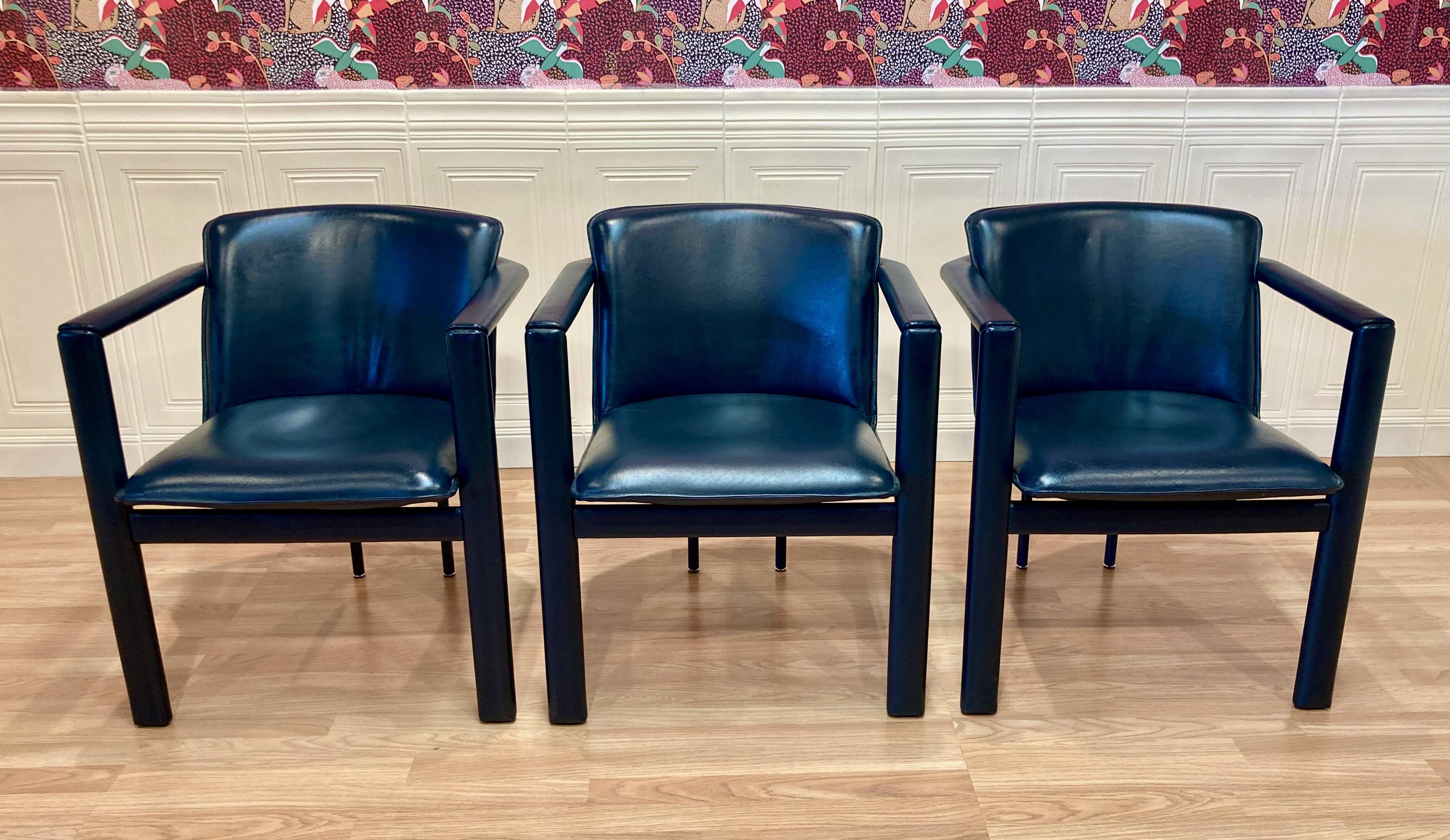 Set of 3 designer leather and metal armchairs.