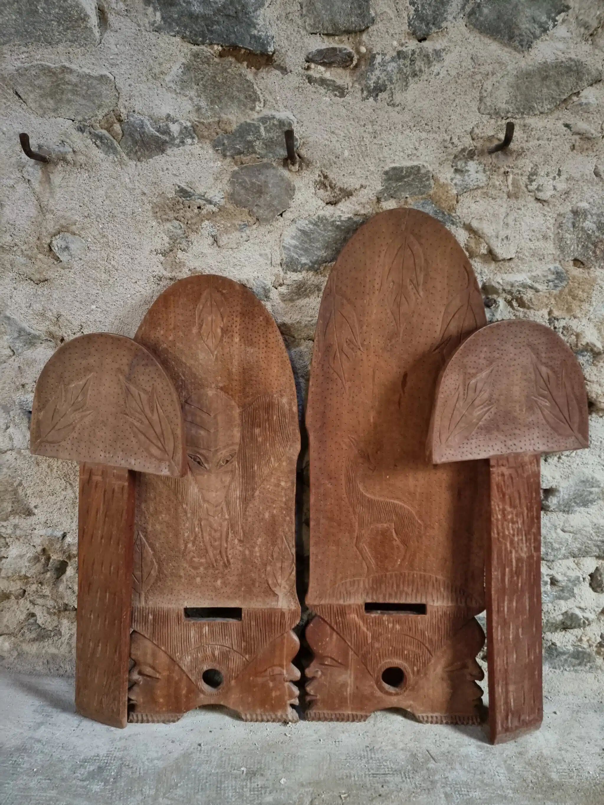 Pair of hand-carved wooden folding chairs – African origin, animal and face motifs, mid-20th century