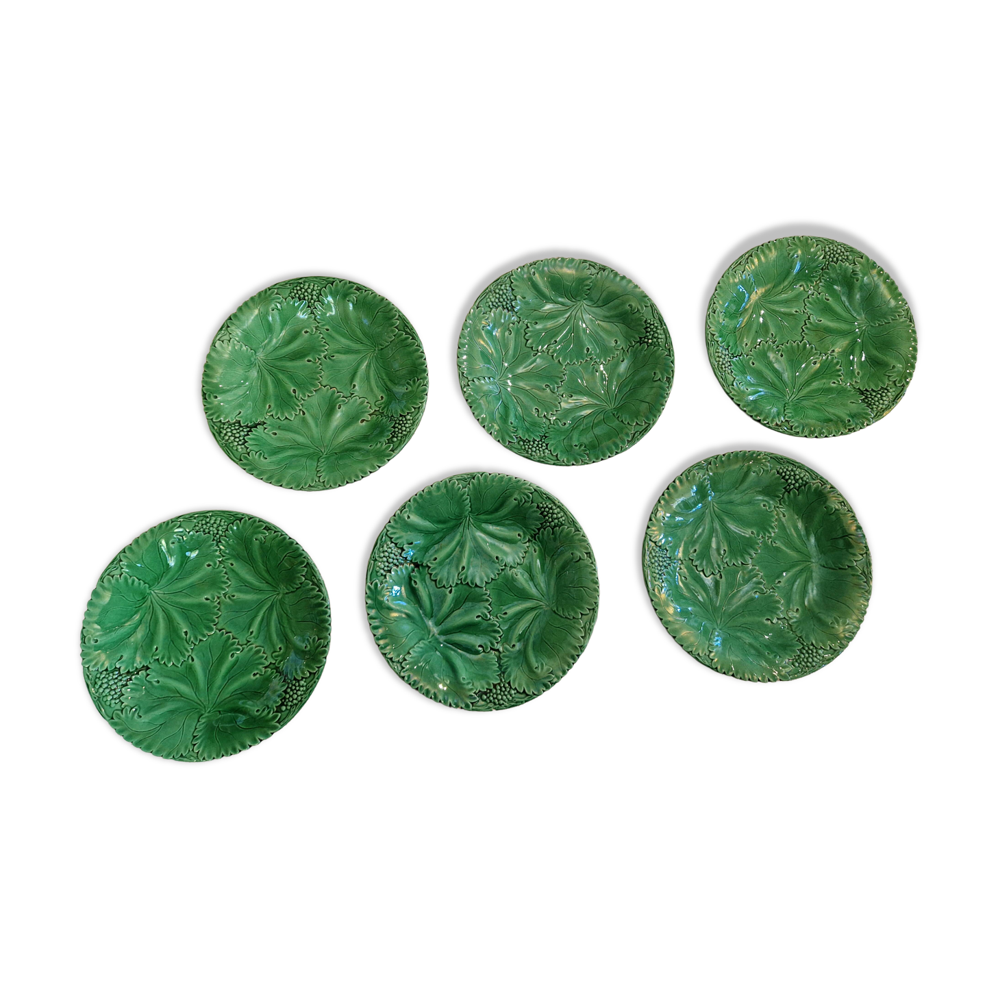 8 green barbotine plates from the early 20th century.
