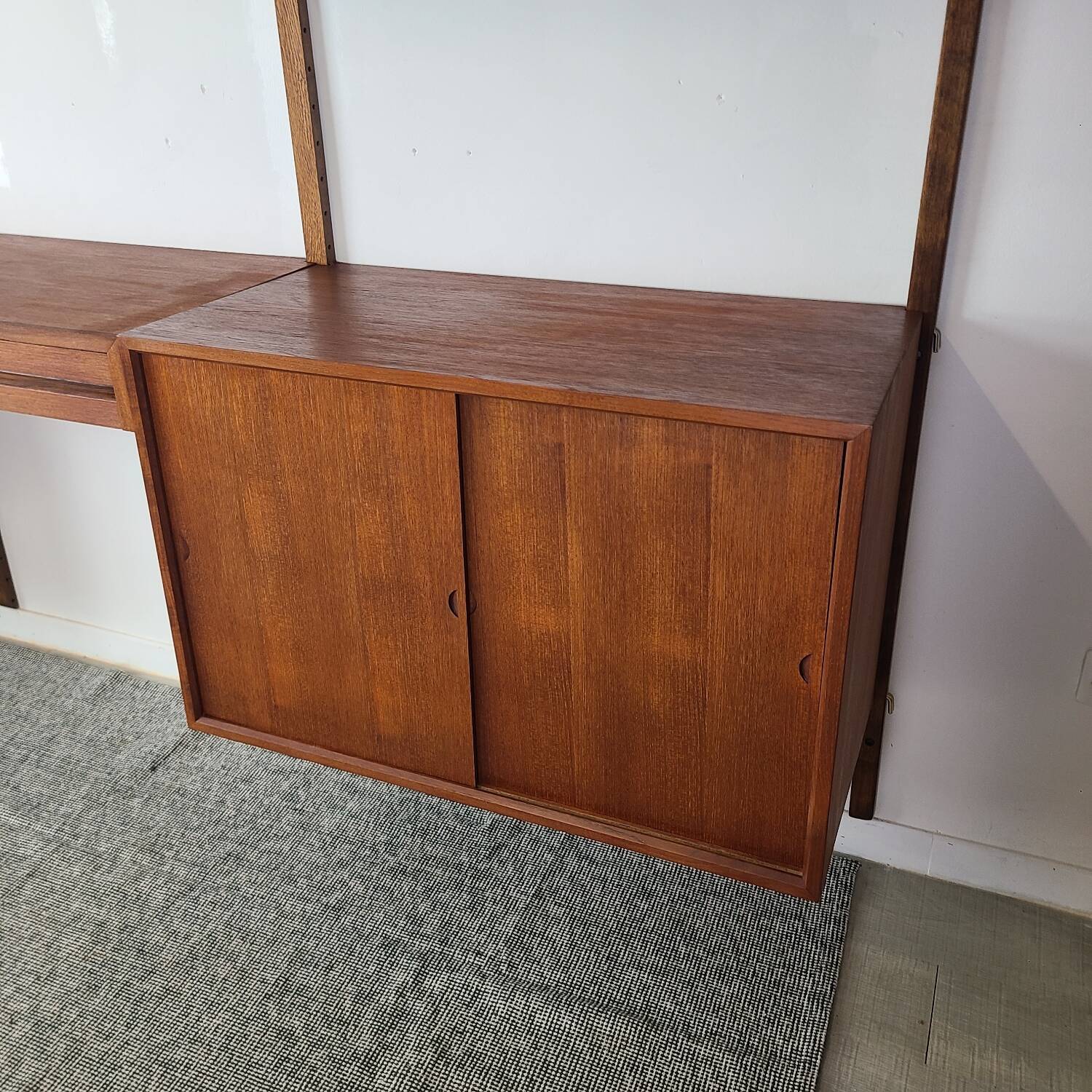 Danish wall-mounted bookshelf designed by Poul Cadovius, Scandinavian design.