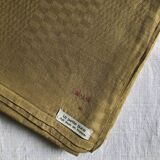 Old damask tablecloth in linen and checkered silk tinted saffron yellow