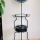 Foldable wrought iron support from the 19th century for a toilet set.