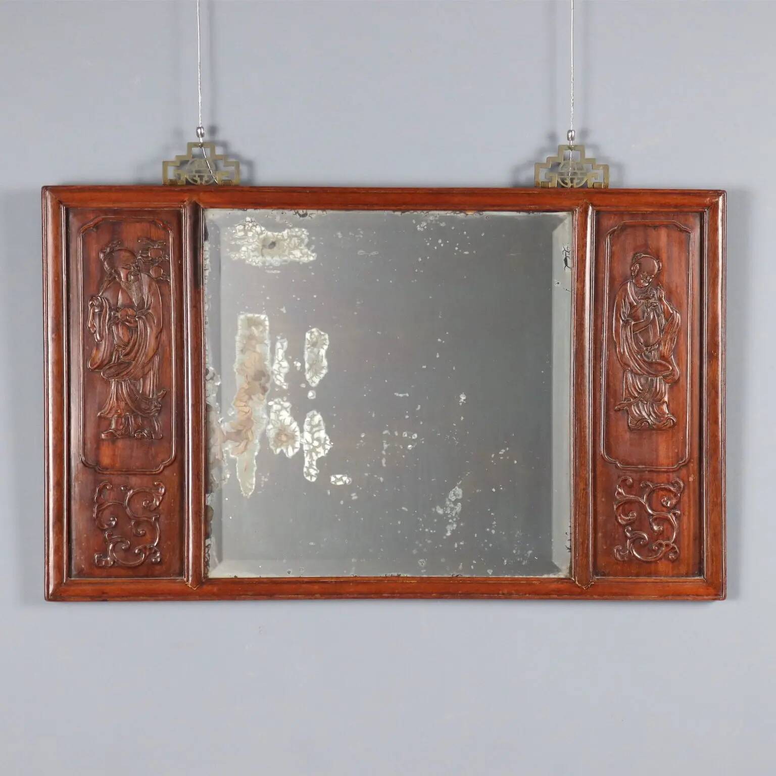 Antique mirror in exotic wood with chinoiserie carvings, 19th century.