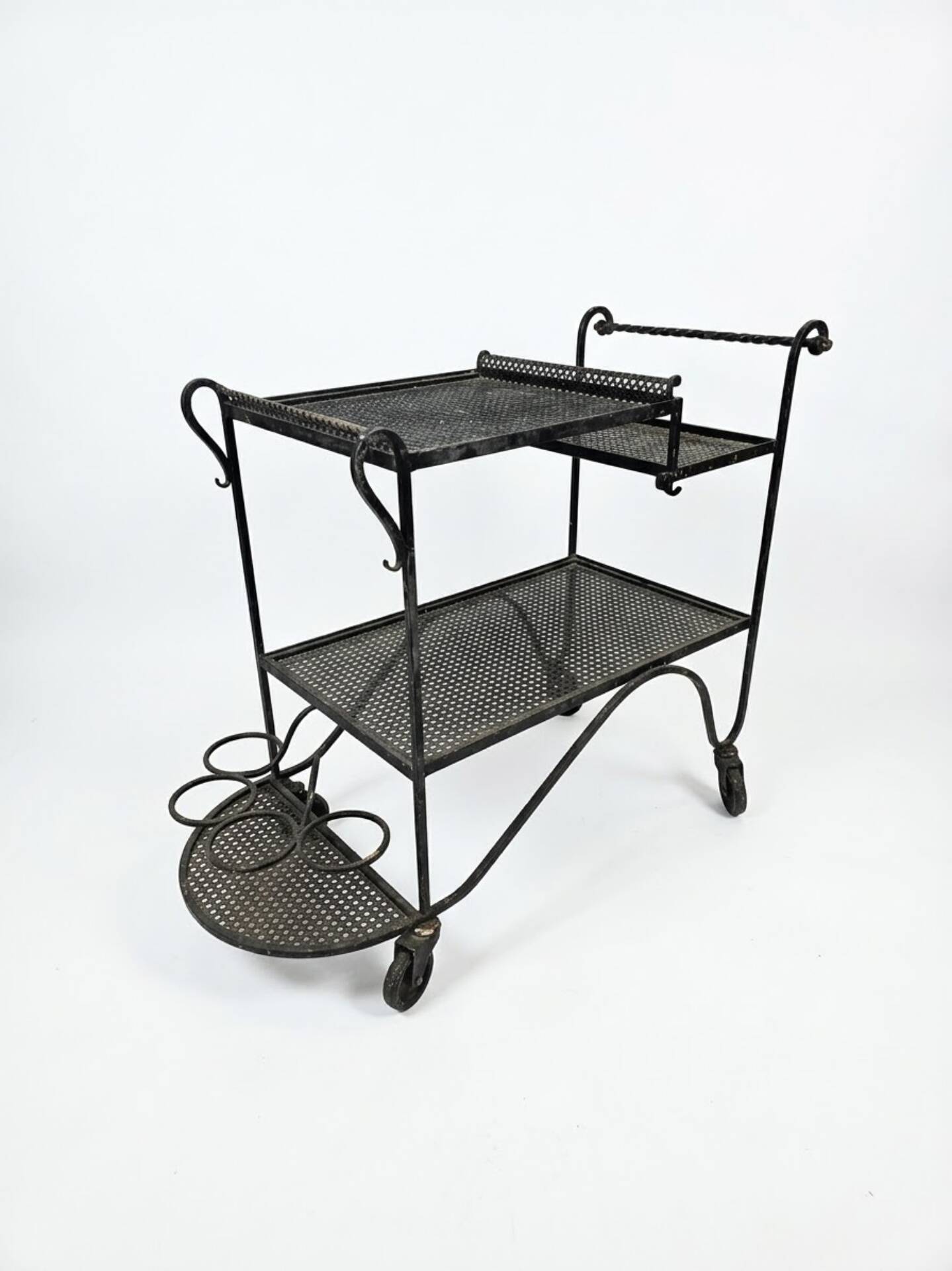Perforated wrought iron rolling dessert trolley