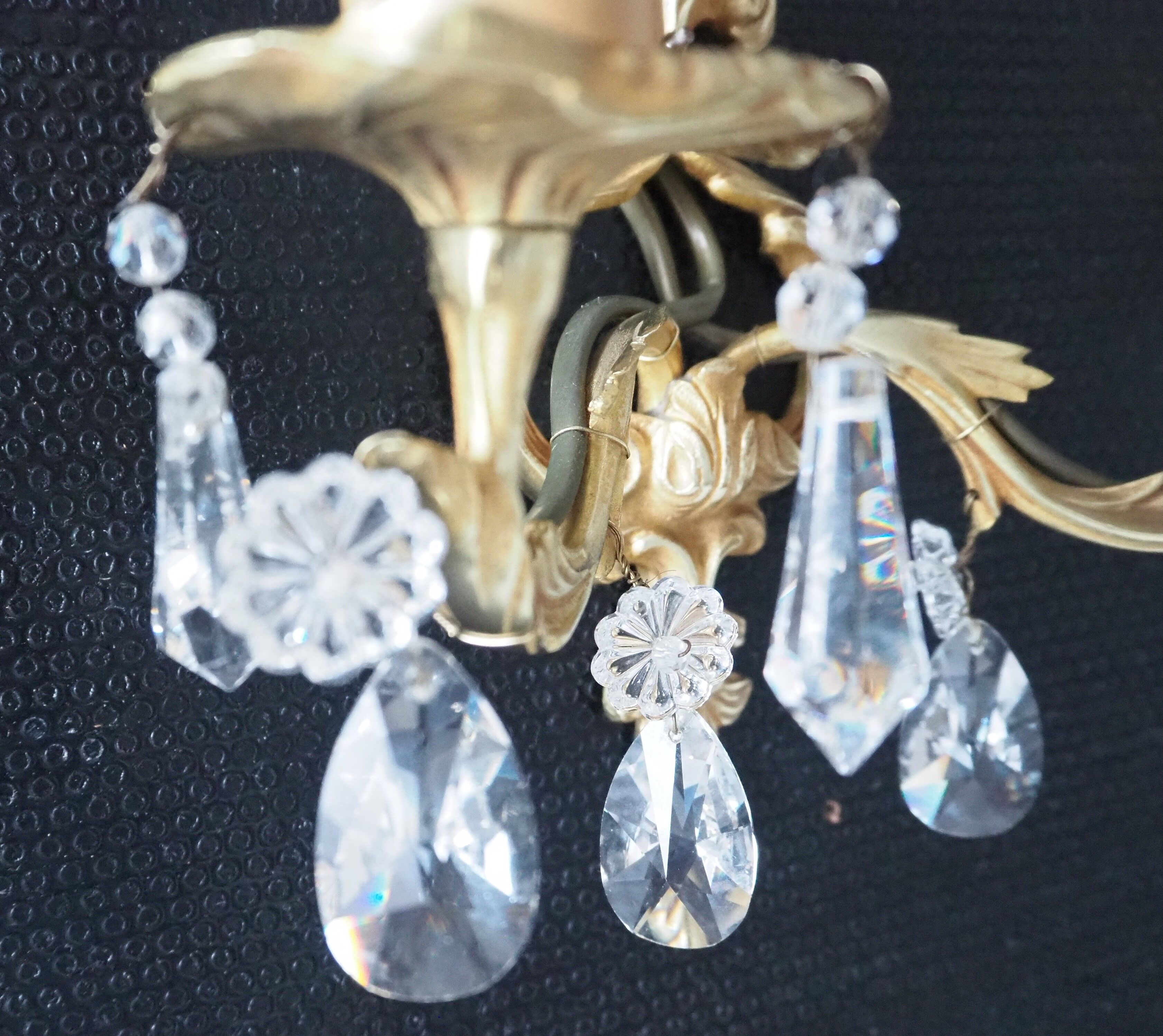 Pair of gilded bronze sconces and crystal pendants
