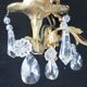 Pair of gilt bronze wall sconces with crystal pendants.
