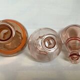 Trio of pink bottle decanters