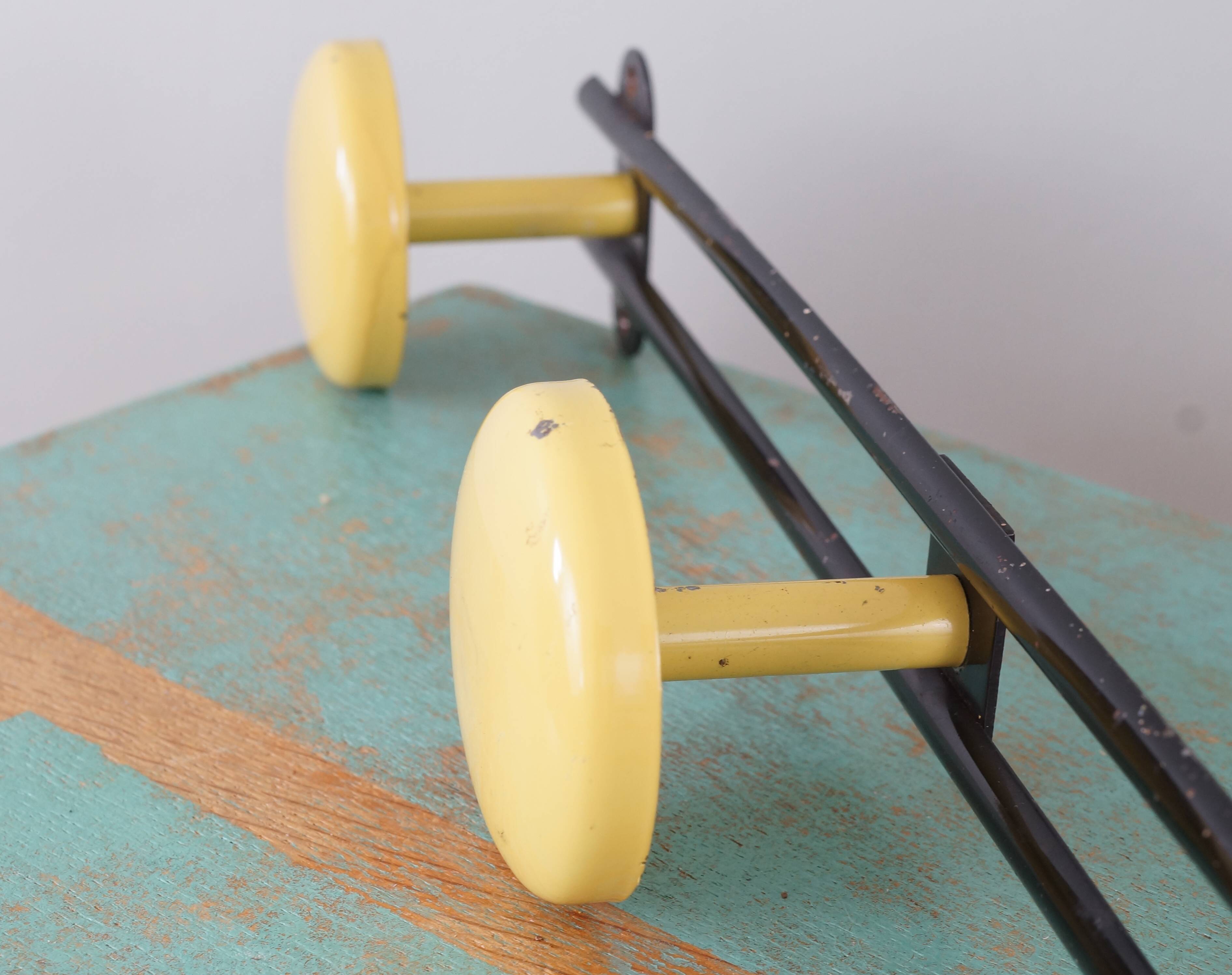 Yellow and black enamelled metal hook, 60s