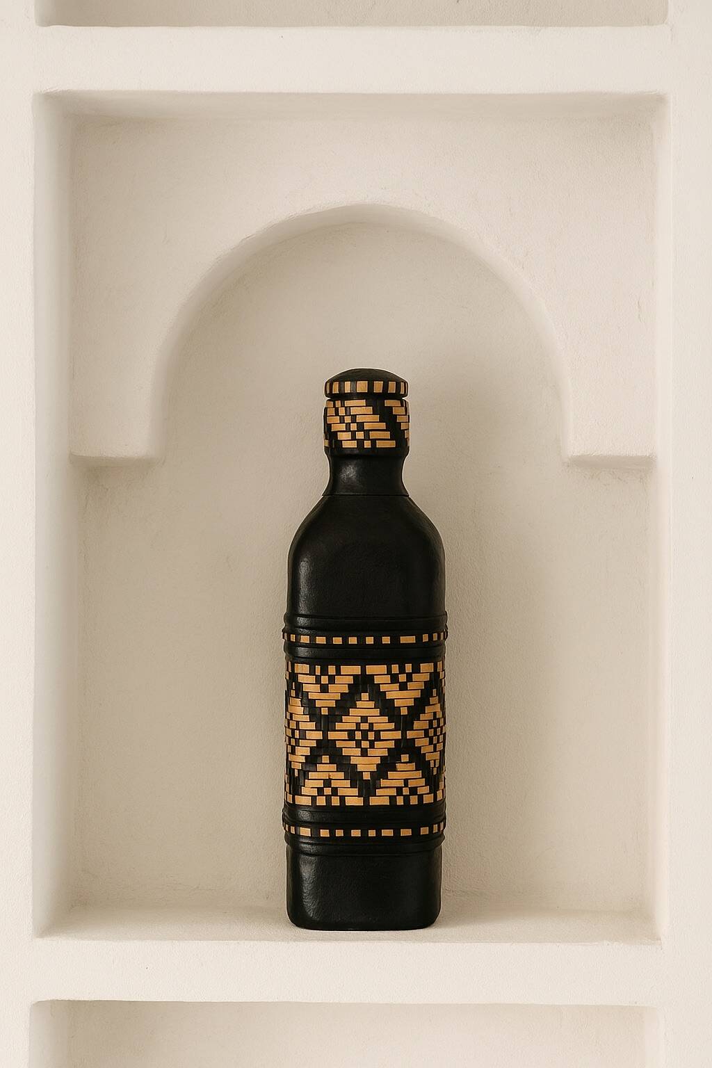 Ethnic decorative bottle in leather and raffia braiding
