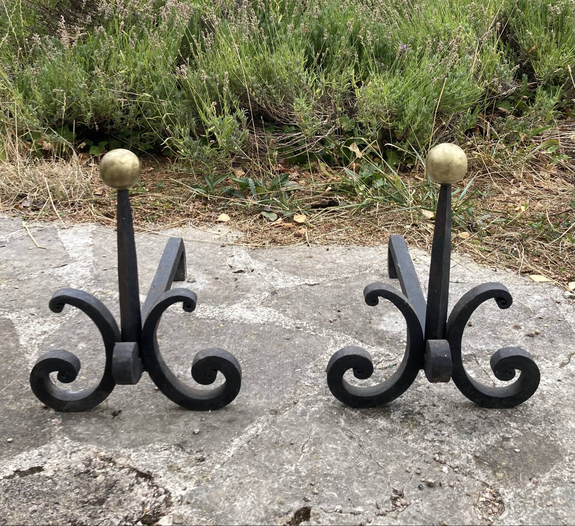 Massive wrought iron chenets from the 19th century topped with brass balls.